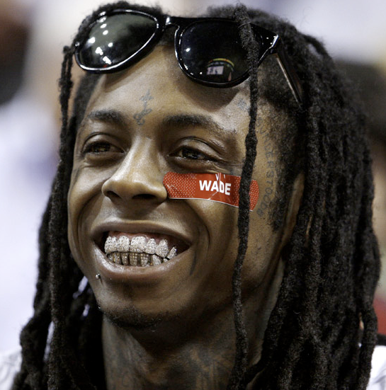 lil wayne teeth grillz. Lil Wayne has an estimated